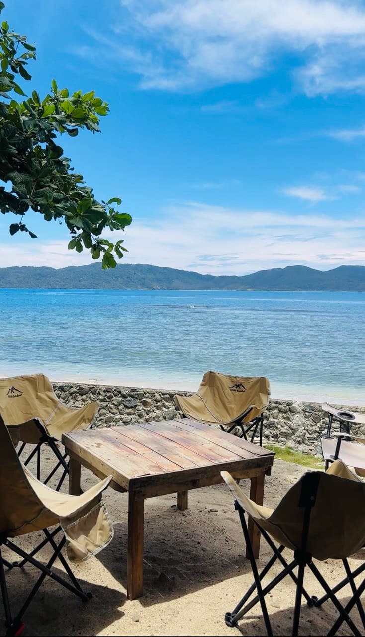 Camp chairs and table facing the bay
