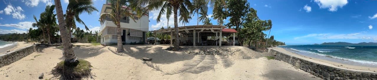The whole Luntiya property — beach house, common area, and shoreline